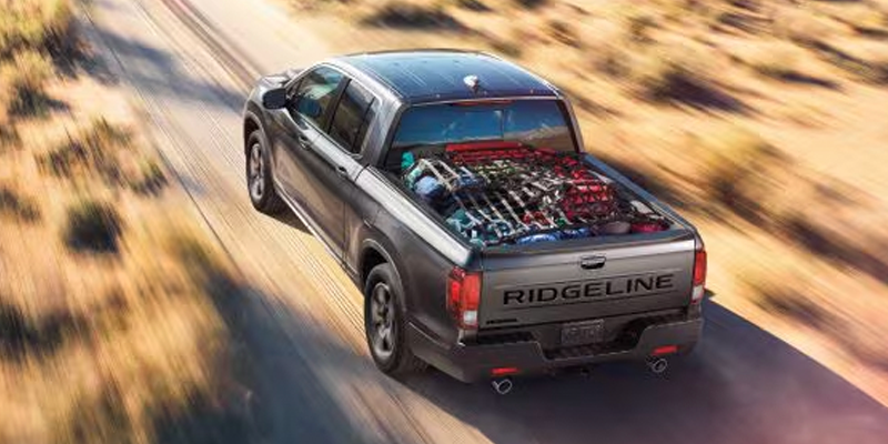 new Honda Ridgeline driving along dirt road