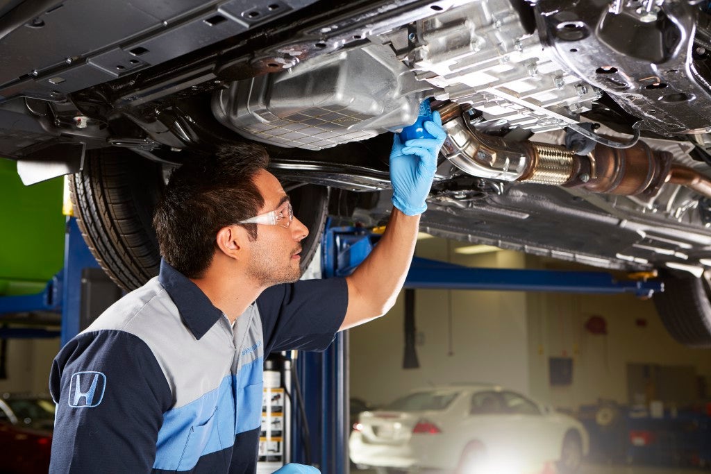 Certified technicians performing oil change service at Fremont Honda of Casper